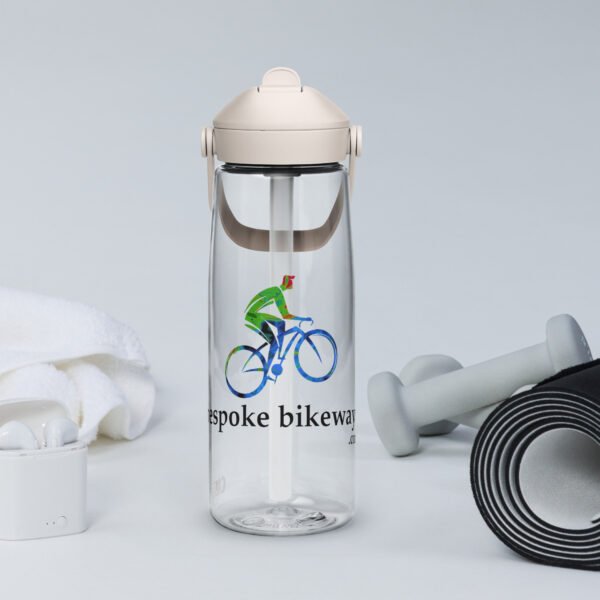 A Bespoke Bikeways branded CamelBak water bottle in Clear color sits amongst workout gear in a typical product display.