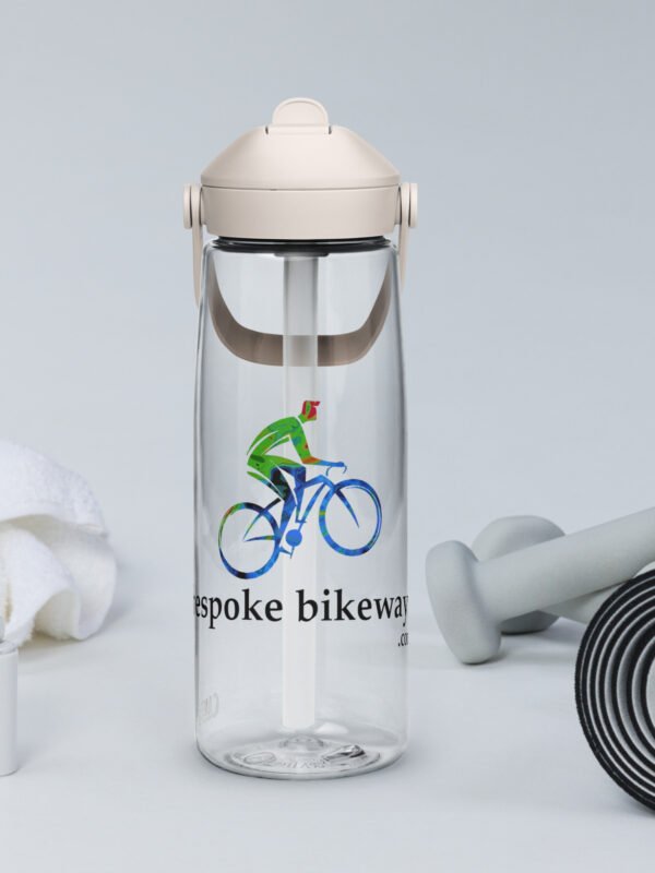 A Bespoke Bikeways branded CamelBak water bottle in Clear color sits amongst workout gear in a typical product display.